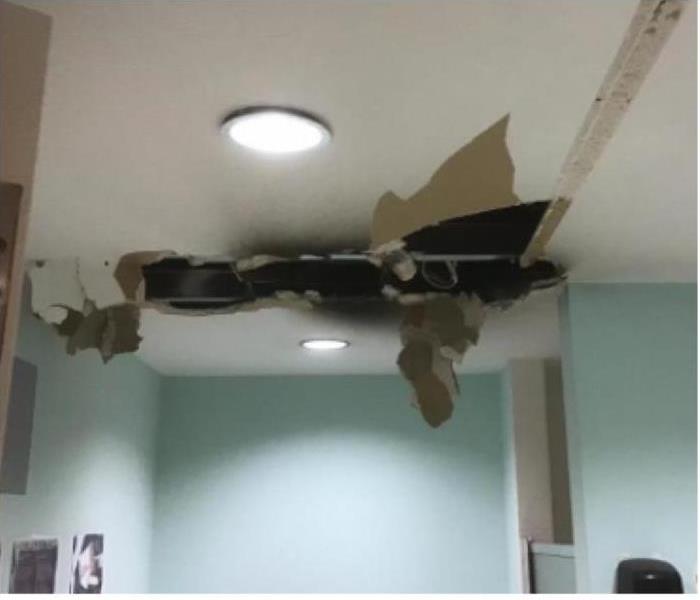 ceiling damaged and blackened by electrical fire