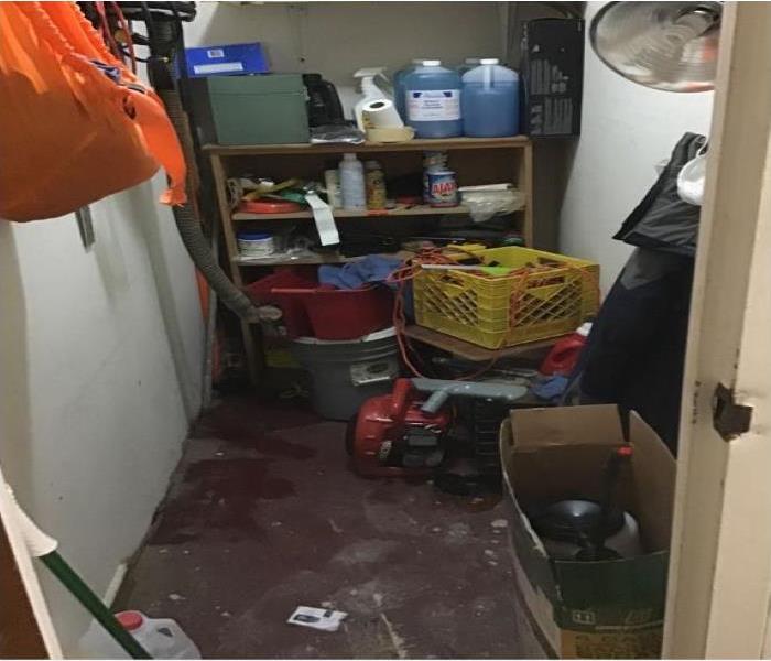 maintenance closet has water on floor and materials throughout 