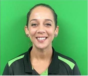 image of female smiling against green background