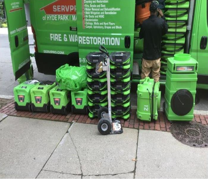 technician unloading drying equipment from SERVPRO van