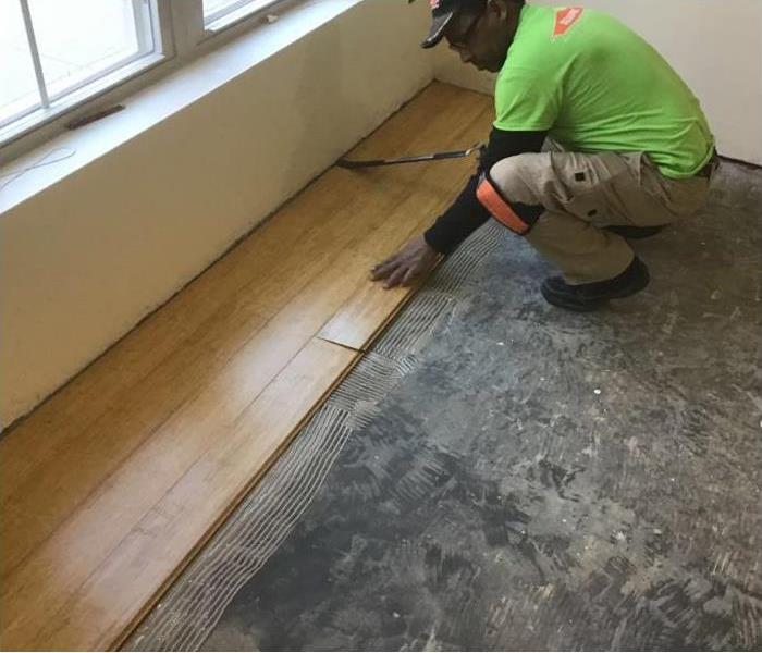 Technician installing hardwood floor