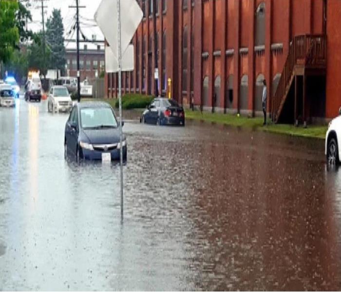 car parked on street flooded by water from hurricane