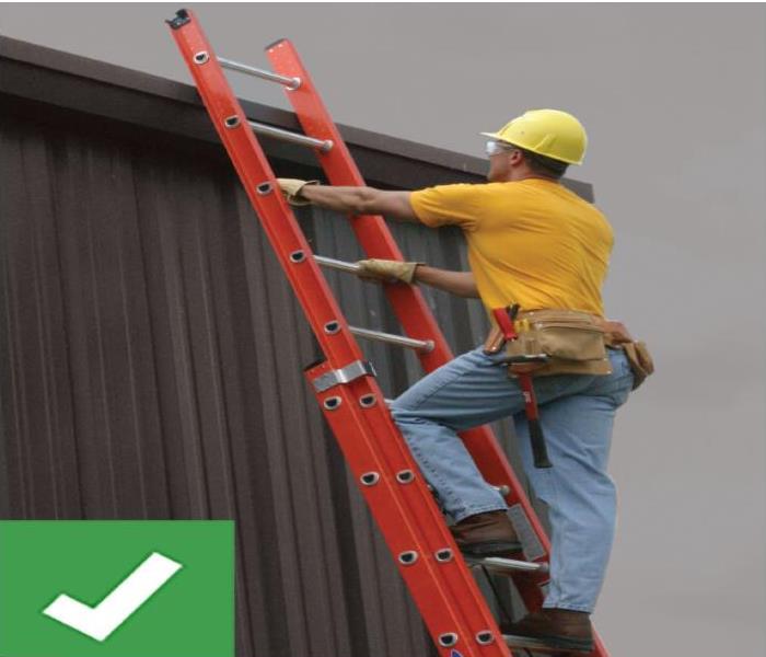 construction worker climbing ladder