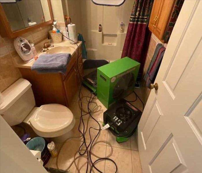 bathroom with water damage mitigation equipment